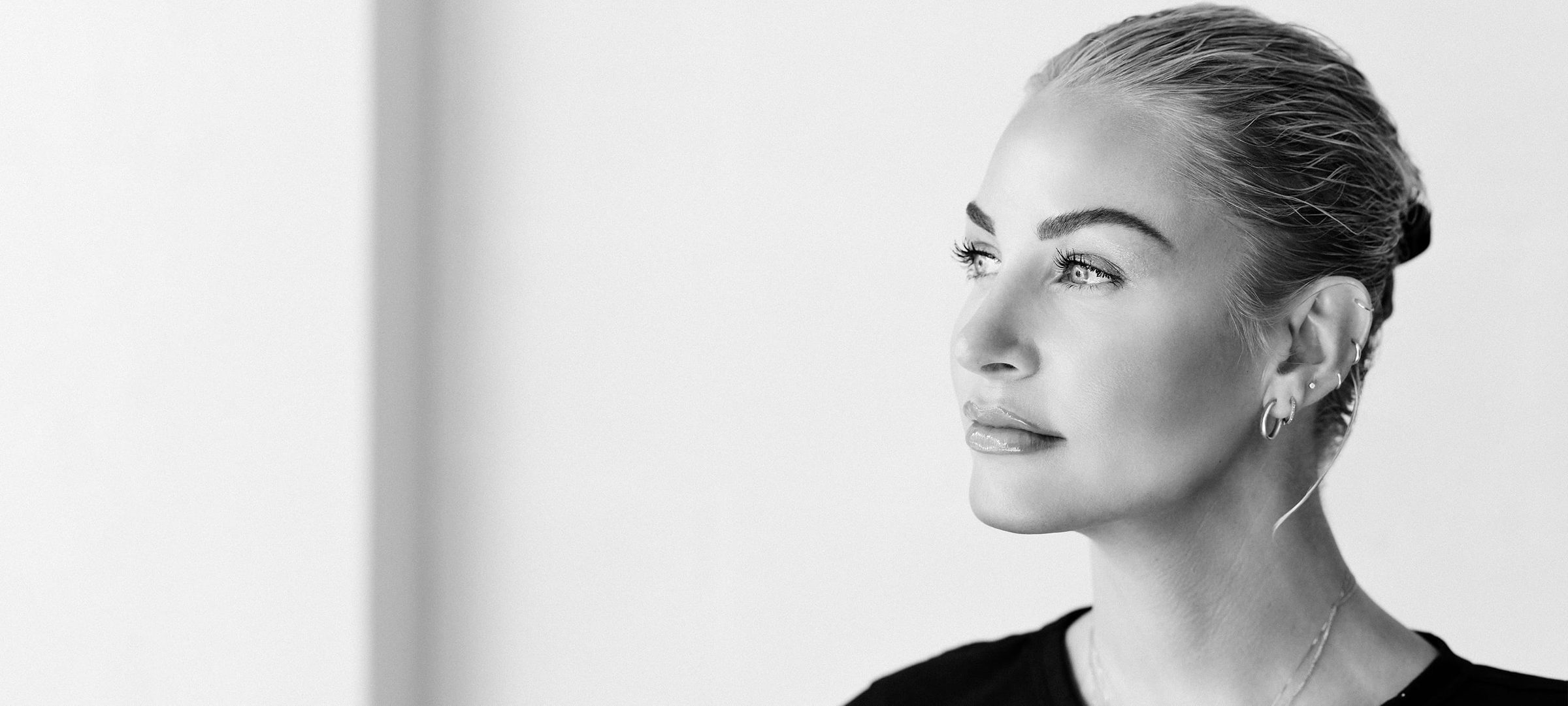 Black and white image of a woman with slick backed hair