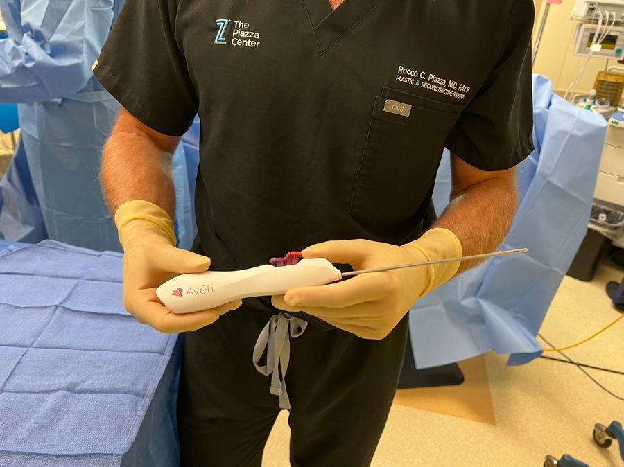 Dr. Rocco Piazza holding the Avéli handheld device used to treat cellulite dimples