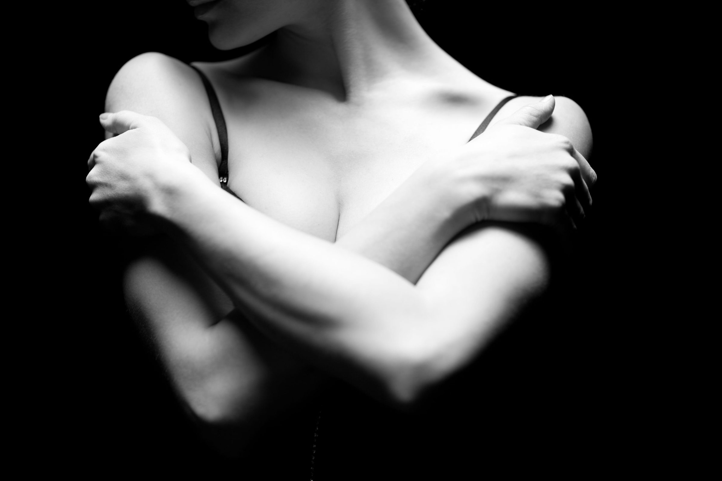 Women with arms crossed around breast