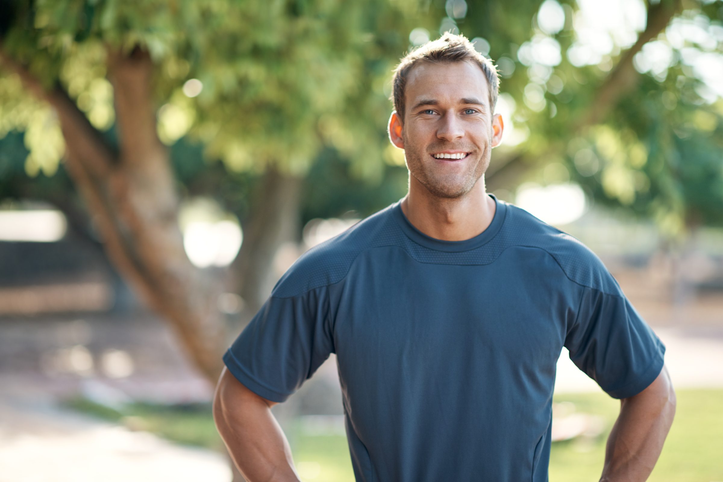 Man outside wearing a blue atheltic shirt